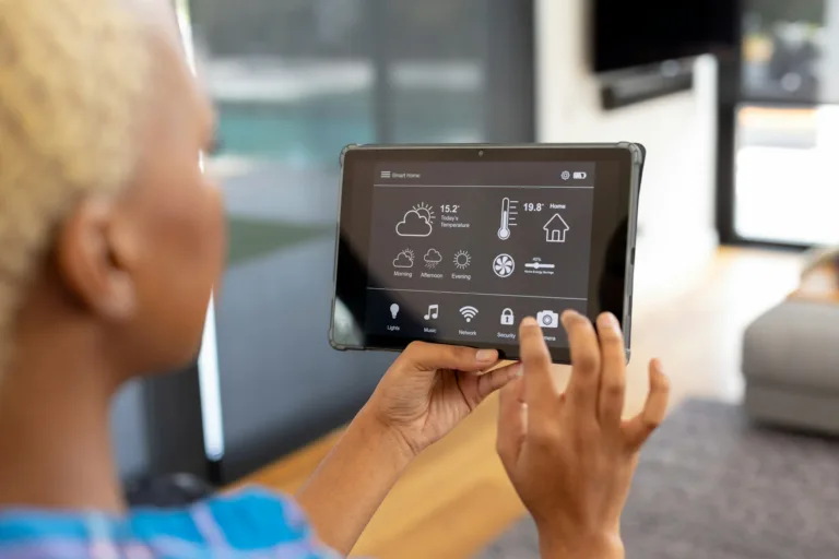 African american woman using tablet with smart home interface